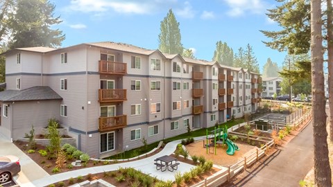 an exterior view of an apartment building with a playground